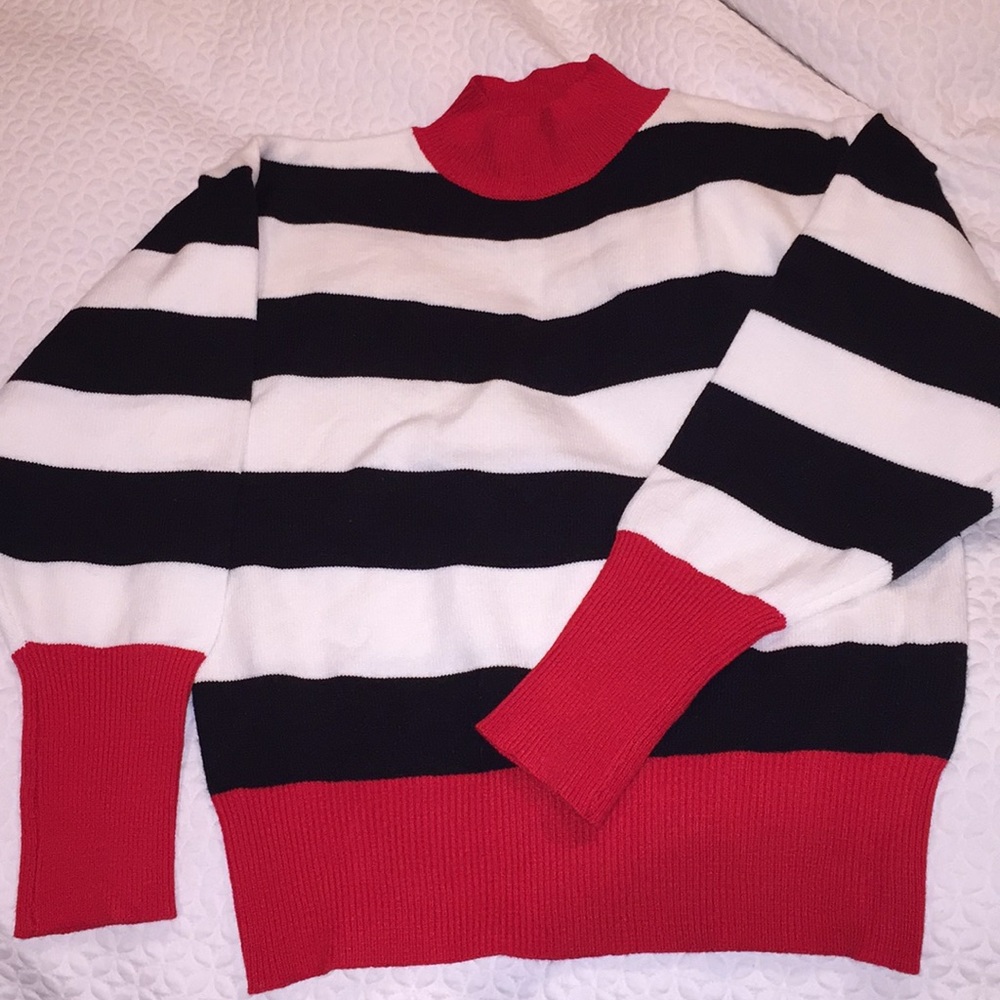 black and white striped sweater with red detailing